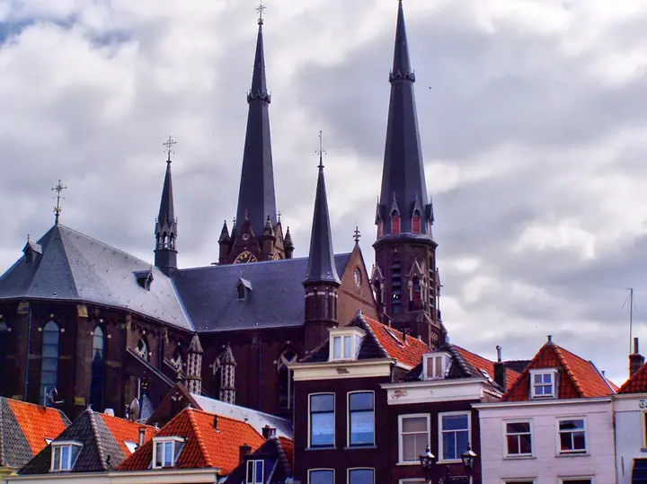 Church spires above the red rooftops of Delft.