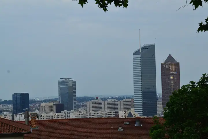 Modern towers rising above the rooftops of Lyon.