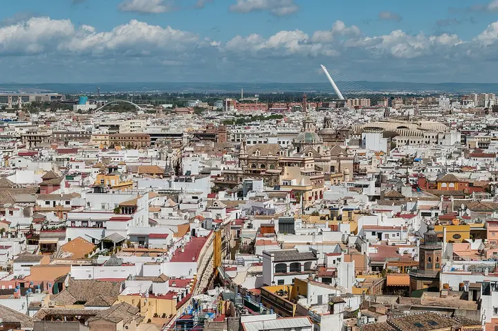 White buildings and church towers across the Seville skyline.